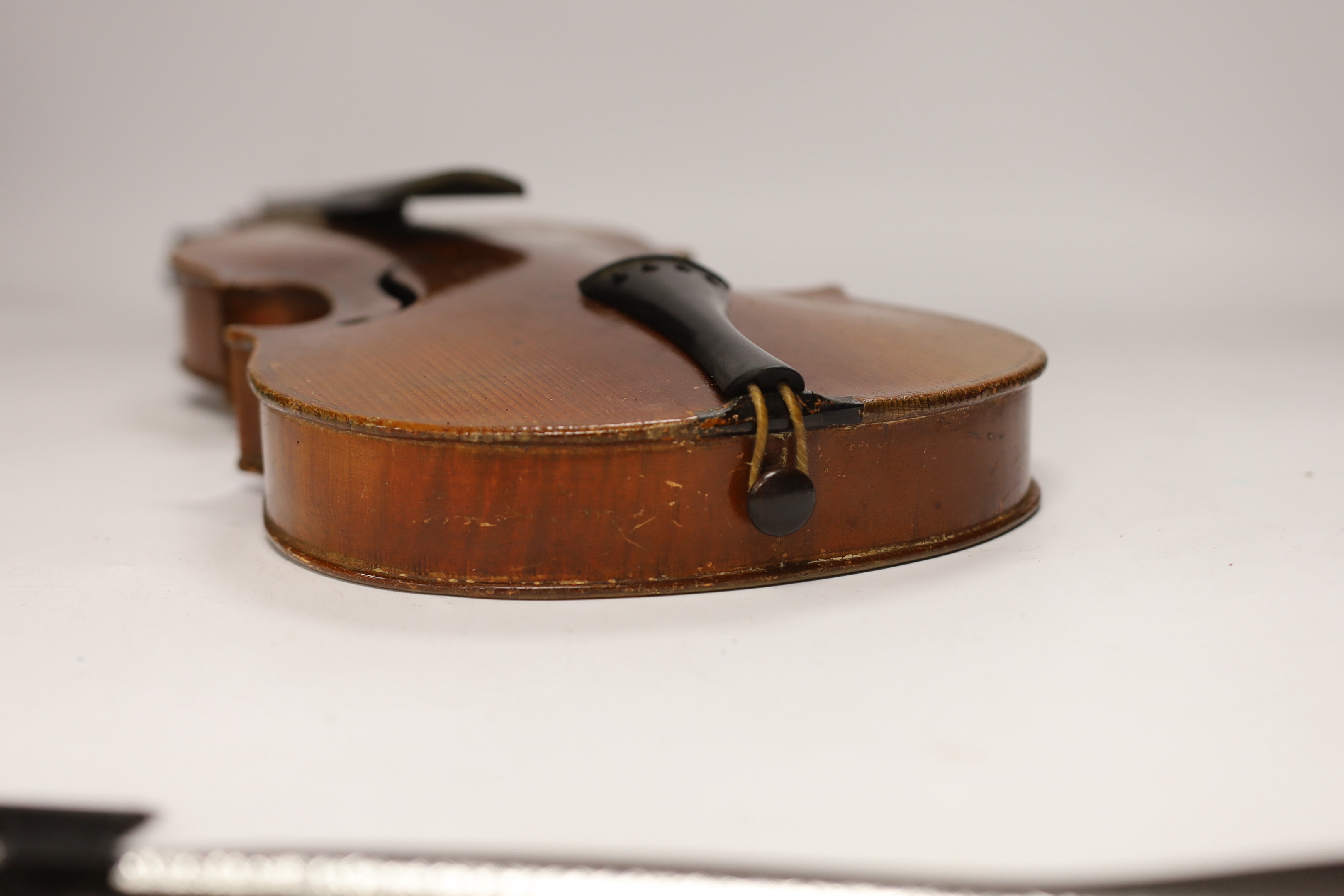 An early twentieth century violin for restoration in an ebonised wooden case, body 36cm (without bow)